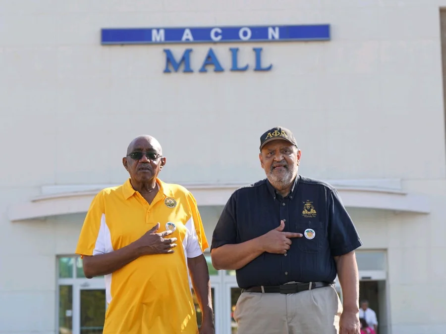 Two brothers of the chapter outside the Macon Mall early voting site, wearing their voting buttons.